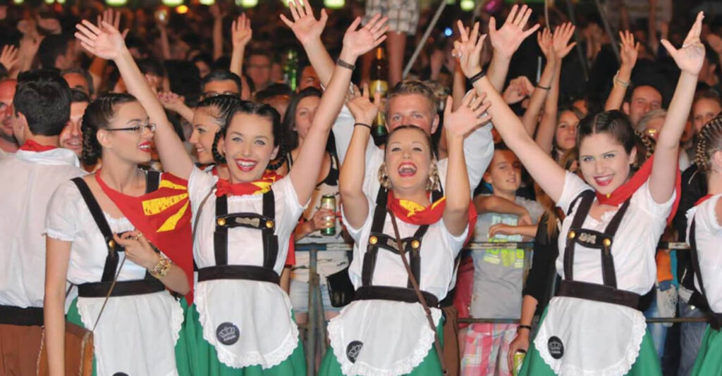 girls raising hands and laughing at Beer Festival in Prilep