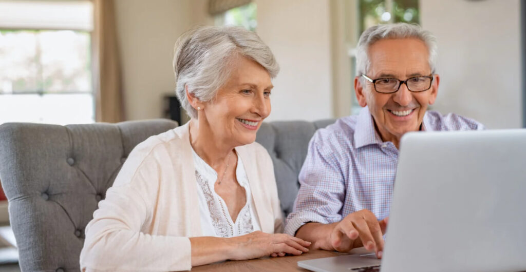seniors couple looking at laptop