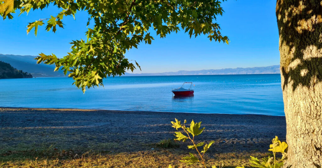 boat near a tranquil empty beach - Lake Ohrid 