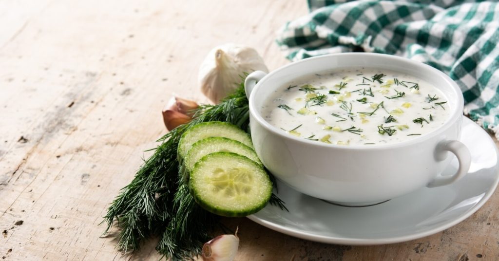 Tarator in a bowl with cucumbers and dill on a side