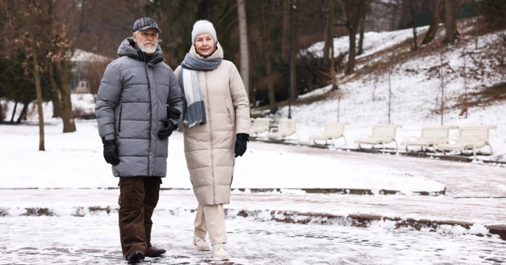 Senior couple walking on snow